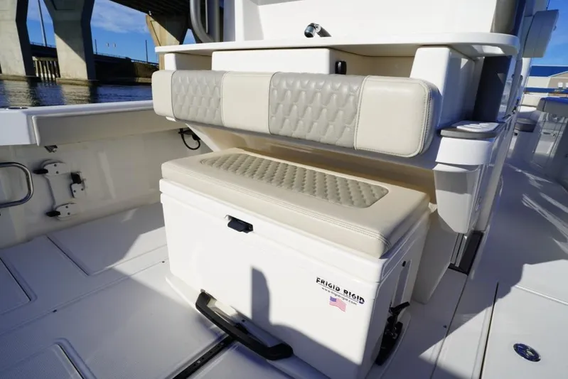  Yacht Photos Pics 2024 Solace 32 CS boat interior with cushioned seating and storage compartment.