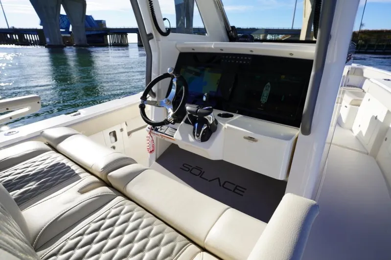  Yacht Photos Pics 2024 Solace 32 CS boat interior with modern helm and luxurious seating.