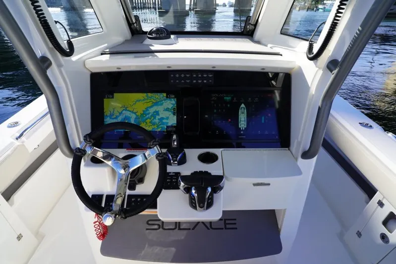  Yacht Photos Pics 2024 Solace 32 CS boat helm with advanced navigation displays and steering wheel.