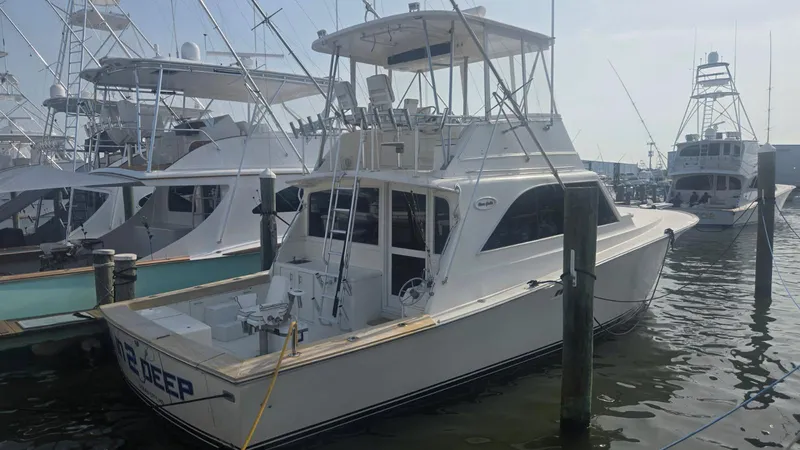 In 2 Deep Yacht Photos Pics 1984 Ocean Yachts 46 Super Sport docked at marina, surrounded by other boats.