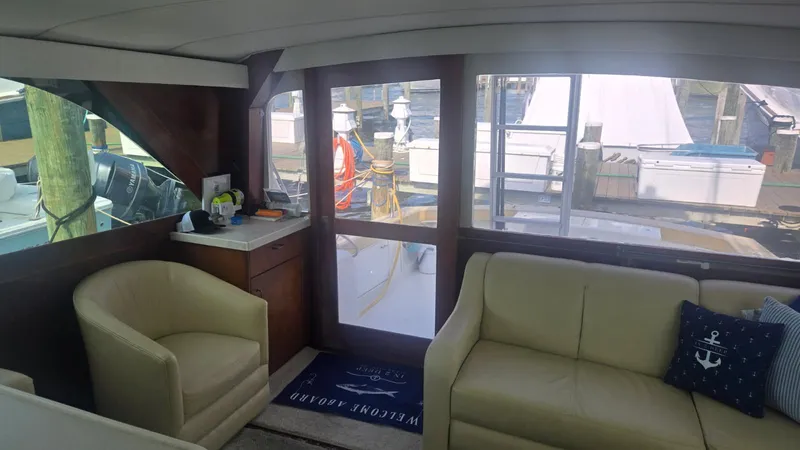 In 2 Deep Yacht Photos Pics Interior of 1984 Ocean Yachts 46 Super Sport with seating and marina view.