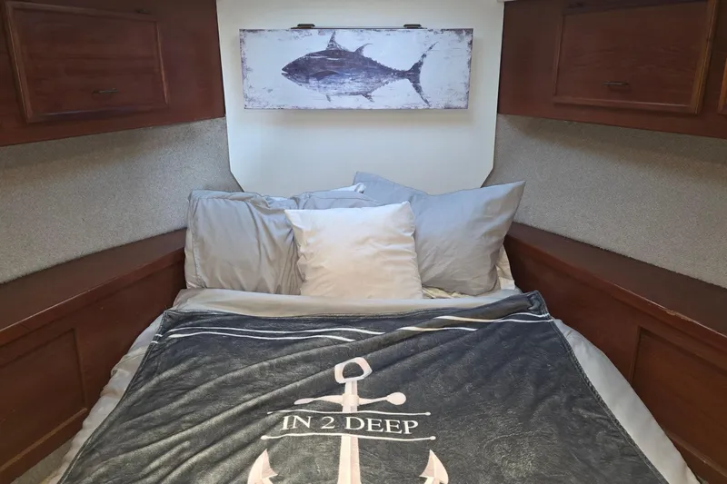 In 2 Deep Yacht Photos Pics Cozy cabin bedroom in 1984 Ocean Yachts 46 Super Sport with nautical decor.