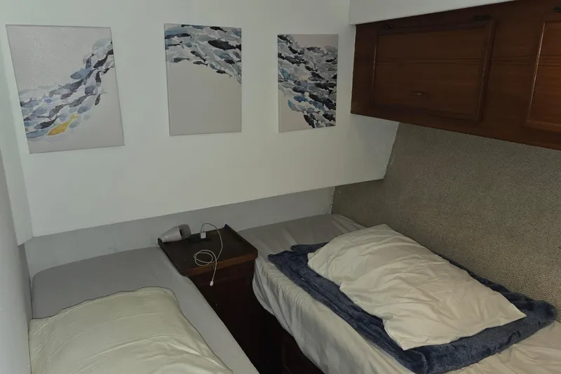 In 2 Deep Yacht Photos Pics Twin beds in a cozy cabin of a 1984 Ocean Yachts 46 Super Sport.