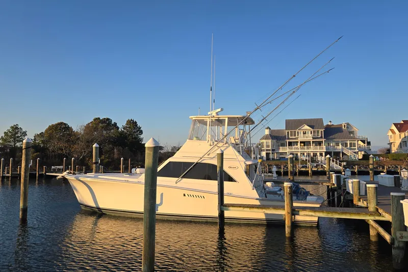 In 2 Deep Yacht Photos Pics 1984 Ocean Yachts 46 Super Sport docked at a marina, with waterfront homes in the background.