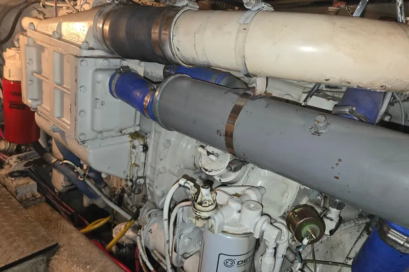 In 2 Deep Yacht Photos Pics Engine compartment of a 1984 Ocean Yachts 46 Super Sport, showcasing mechanical components.