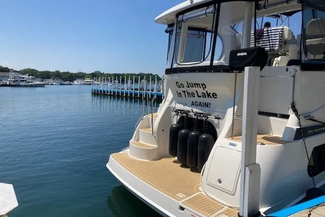 Go Jump In The Lake Yacht Photos Pics 2003 Silverton 39 Motor Yacht docked with humorous "Go Jump In The Lake Again!" sign.