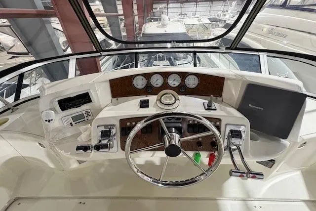 Go Jump In The Lake Yacht Photos Pics 2003 Silverton 39 Motor Yacht helm with steering wheel and control panel.