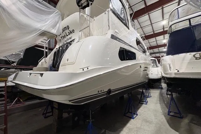 Go Jump In The Lake Yacht Photos Pics 2003 Silverton 39 Motor Yacht in storage, elevated on stands in a boatyard.