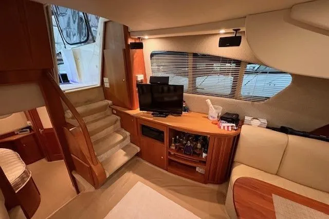 Go Jump In The Lake Yacht Photos Pics Interior of 2003 Silverton 39 Motor Yacht with cozy seating and entertainment area.