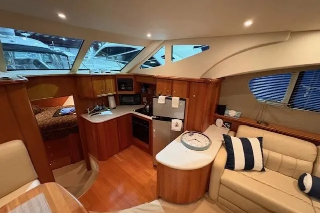 Go Jump In The Lake Yacht Photos Pics 2003 Silverton 39 Motor Yacht interior with kitchen and seating area.