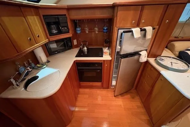 Go Jump In The Lake Yacht Photos Pics 2003 Silverton 39 Motor Yacht kitchen with modern appliances and wooden cabinetry.