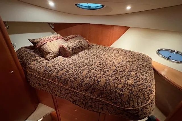 Go Jump In The Lake Yacht Photos Pics Luxurious bedroom in 2003 Silverton 39 Motor Yacht with elegant bedding and porthole window.