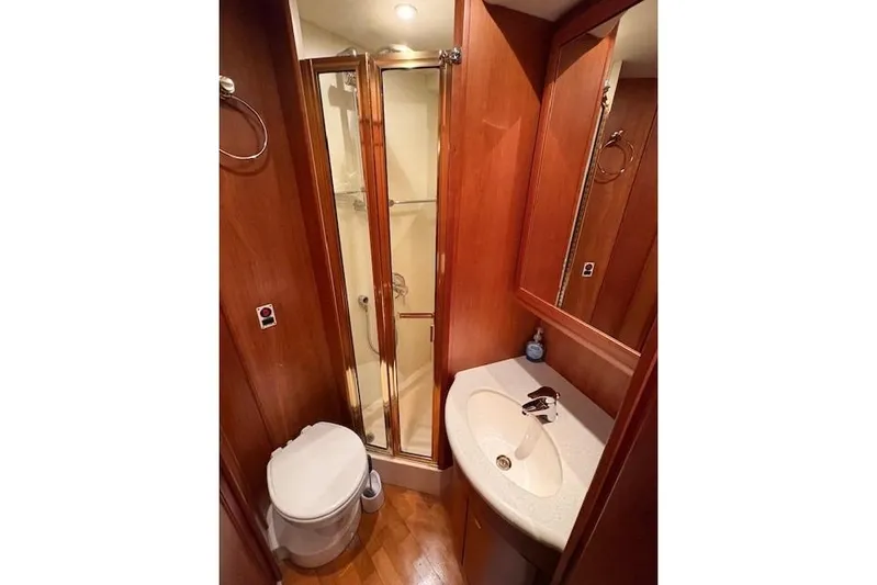 Go Jump In The Lake Yacht Photos Pics 2003 Silverton 39 Motor Yacht bathroom with shower, sink, and toilet.