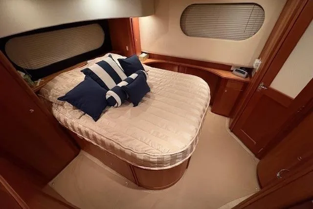 Go Jump In The Lake Yacht Photos Pics Luxurious bedroom in 2003 Silverton 39 Motor Yacht with cozy bedding and elegant wood finishes.