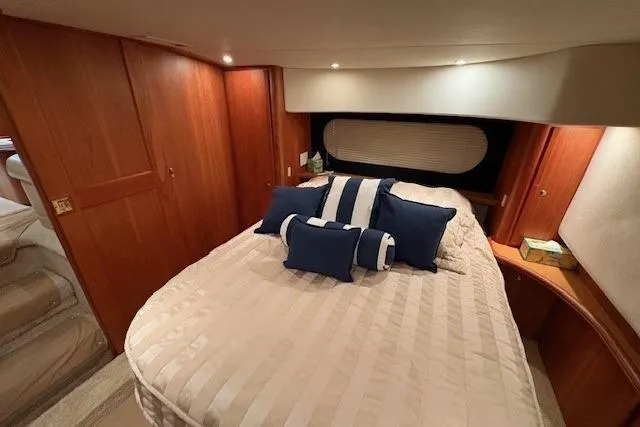 Go Jump In The Lake Yacht Photos Pics Luxurious bedroom interior of 2003 Silverton 39 Motor Yacht with elegant bedding and wood finish.