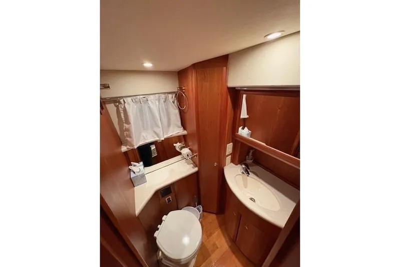 Go Jump In The Lake Yacht Photos Pics 2003 Silverton 39 Motor Yacht bathroom with wood cabinetry and modern fixtures.