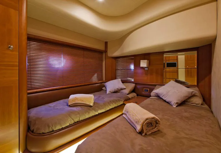  Yacht Photos Pics Luxurious cabin interior of 2006 Azimut 62 yacht with twin beds and wooden accents.