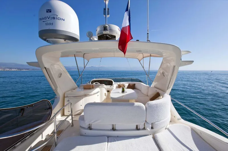  Yacht Photos Pics Luxurious 2006 Azimut 62 yacht with spacious deck, ocean view, and flag.