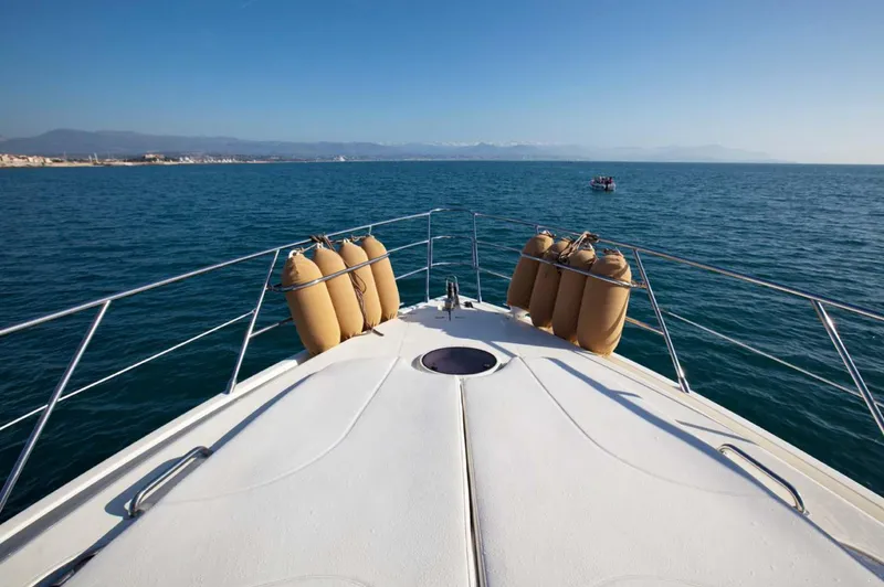  Yacht Photos Pics Bow view of 2006 Azimut 62 yacht cruising on calm blue sea.