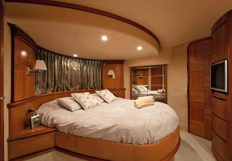  Yacht Photos Pics Luxurious bedroom interior of 2006 Azimut 62 yacht with round bed and elegant wood finishes.