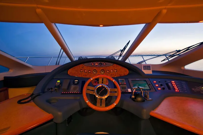  Yacht Photos Pics Luxurious 2006 Azimut 62 yacht cockpit at sunset, featuring advanced navigation controls.