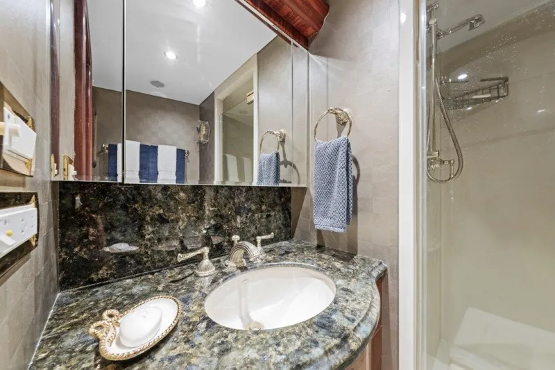 Amajen Yacht Photos Pics Luxurious bathroom in 2006 Cheoy Lee Motor Yacht with marble countertop and modern shower.