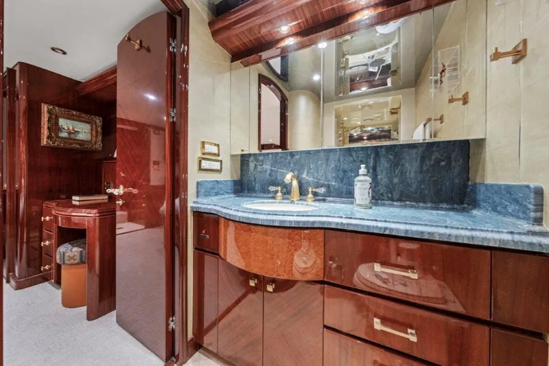 Amajen Yacht Photos Pics Luxurious bathroom in 2006 Cheoy Lee Motor Yacht with elegant wood cabinetry and marble countertop.