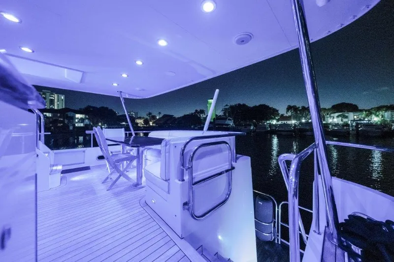 Amajen Yacht Photos Pics Luxurious 2006 Cheoy Lee motor yacht deck illuminated at night, featuring modern seating and ambient lighting.