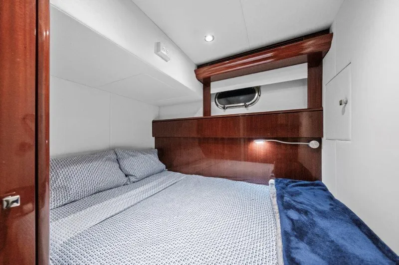 Amajen Yacht Photos Pics Luxurious cabin interior of 2006 Cheoy Lee Motor Yacht with cozy bedding and elegant wood finish.