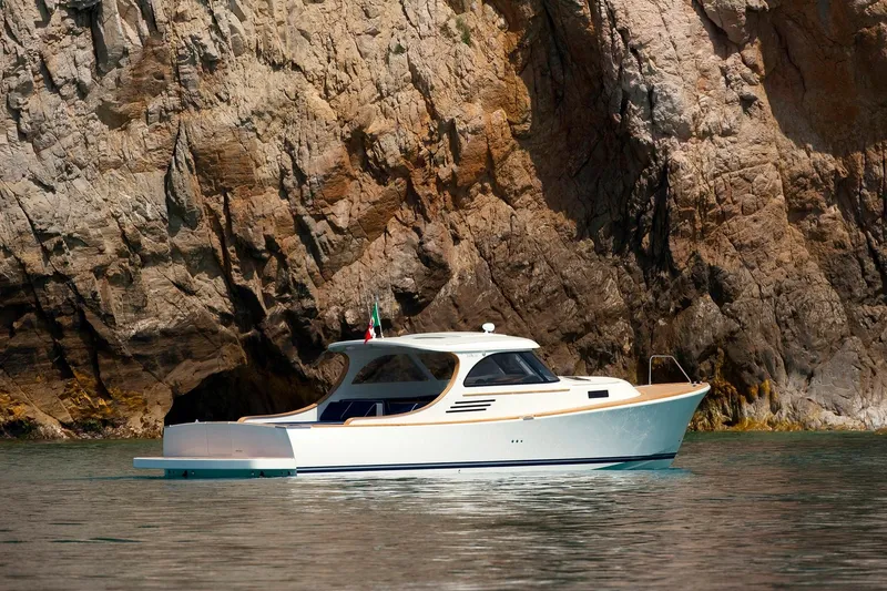 36 Yacht Photos Pics Modern Toy 36 yacht cruising near rocky cliffs, 2025 model.