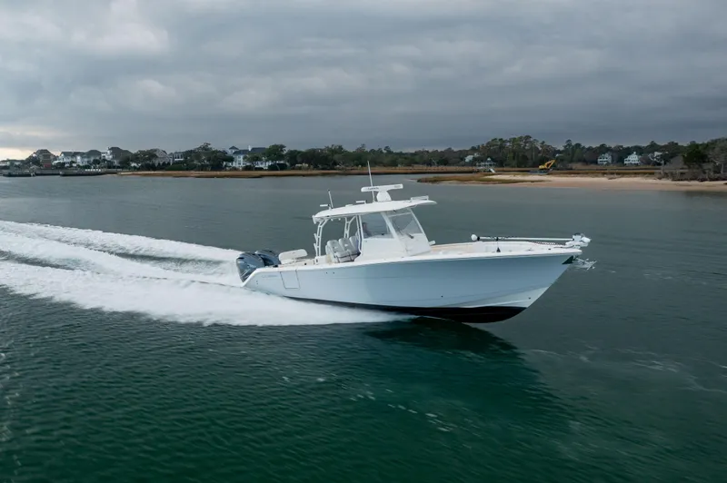  Yacht Photos Pics 2020 Cobia 350 Center Console boat cruising on a calm coastal waterway.