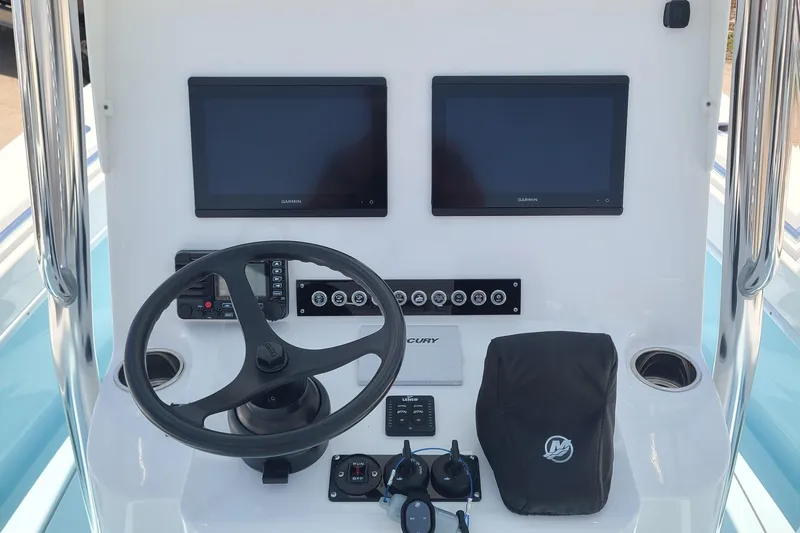  Yacht Photos Pics 2023 Contender 25 Tournament boat dashboard with dual screens and steering wheel.