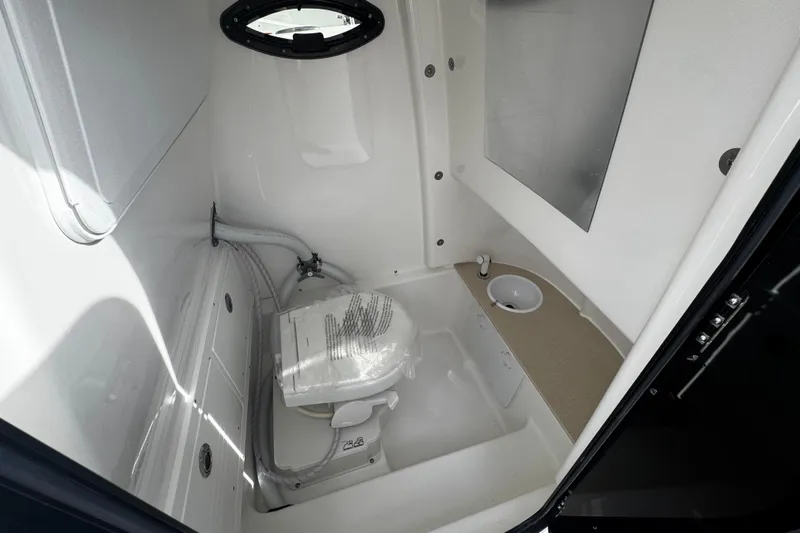  Yacht Photos Pics 2026 Sea Pro 262 Offshore boat bathroom with toilet and sink, compact and modern design.