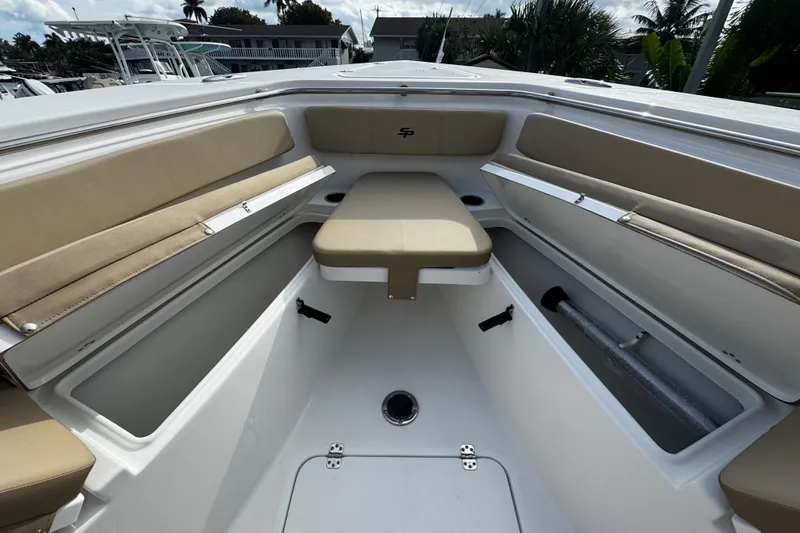  Yacht Photos Pics 2026 Sea Pro 262 Offshore boat interior with beige seating and storage compartments.