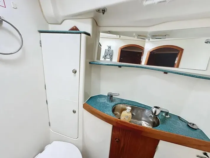  Yacht Photos Pics Bathroom interior of 2001 Jeanneau Sun Odyssey 43 DS yacht, featuring sink and storage.