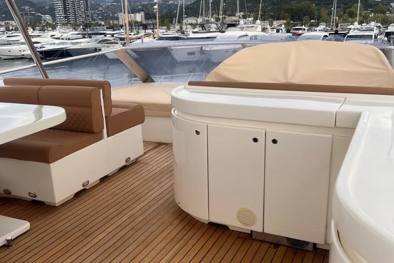  Yacht Photos Pics Luxurious 2005 Posillipo Technema 80 yacht deck with seating and marina view.