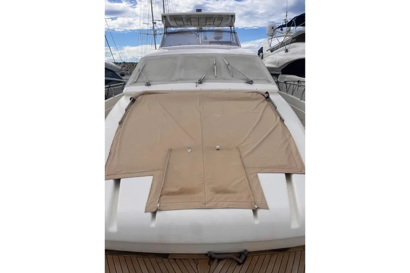  Yacht Photos Pics 2005 Posillipo Technema 80 yacht with beige cover on deck, docked under cloudy sky.