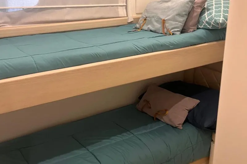  Yacht Photos Pics Bunk beds with teal bedding in a 2005 Posillipo Technema 80 yacht cabin.