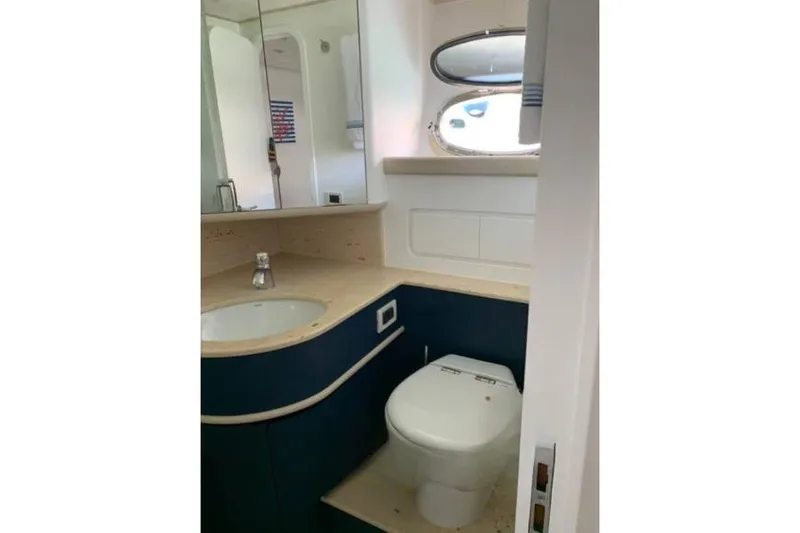  Yacht Photos Pics Luxurious bathroom in 2005 Posillipo Technema 80 yacht with modern fixtures and porthole window.