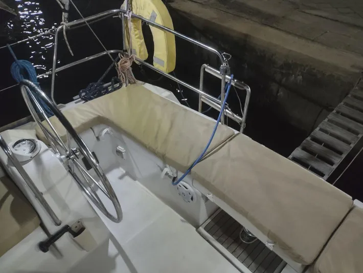 Tiffany Nicole Yacht Photos Pics Cockpit of 2011 Beneteau Oceanis 43 Family sailboat at night, featuring steering wheel and seating.