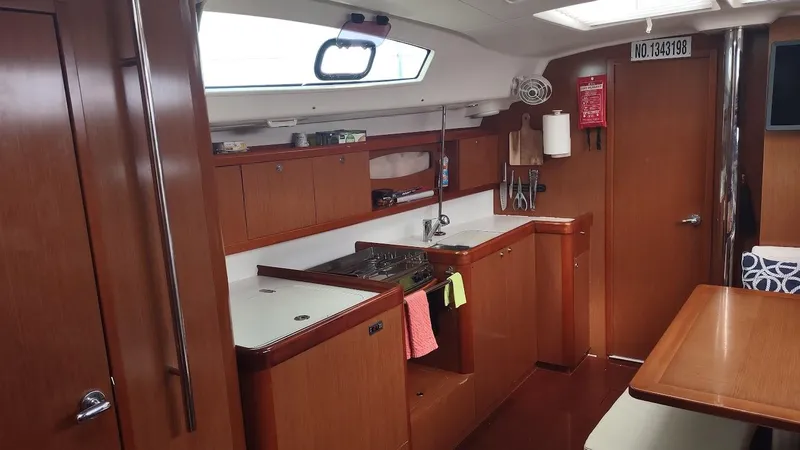 Tiffany Nicole Yacht Photos Pics Interior of 2011 Beneteau Oceanis 43 Family yacht, featuring a well-equipped kitchen and dining area.
