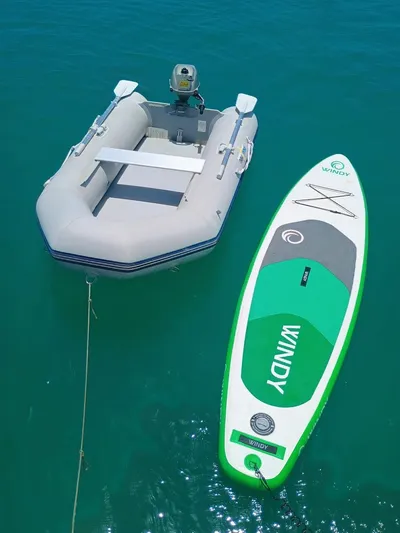 Tiffany Nicole Yacht Photos Pics Inflatable boat and paddleboard on clear water, near a 2011 Beneteau Oceanis 43 Family yacht.