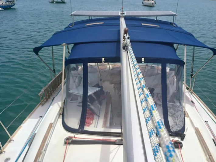 Tiffany Nicole Yacht Photos Pics Beneteau Oceanis 43 Family sailboat, 2011 model, with blue canopy on calm water.