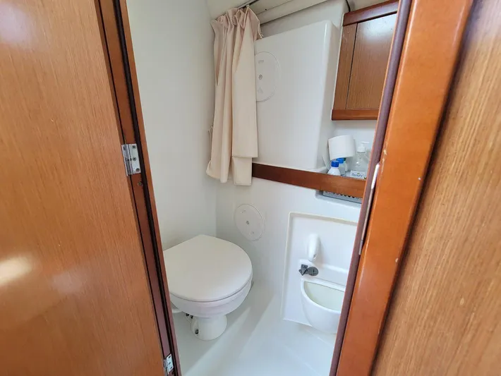 Tiffany Nicole Yacht Photos Pics Bathroom interior of 2011 Beneteau Oceanis 43 Family yacht, featuring toilet and storage.
