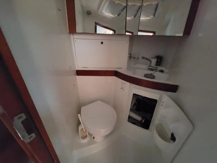 Tiffany Nicole Yacht Photos Pics Bathroom interior of 2011 Beneteau Oceanis 43 Family yacht, featuring toilet and sink.