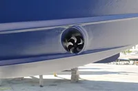 2008 Rinker 260 boat hull with a bow thruster in a marina setting.