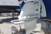 Close-up of a 2008 Rinker 260 boat's outboard motor and propeller.