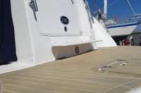 2008 Rinker 260 boat with teak deck and white hull in marina setting.