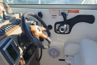 2008 Rinker 260 boat cockpit with steering wheel and control panel.