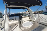 2008 Rinker 260 boat interior with seating and table, docked at marina.